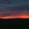 Sun setting over paddocks