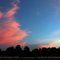 Sunset, pink clouds and tiny moon