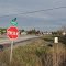 This means STOP in Mohawk language.  These are located on side roads, the main road is in English,  see the one by the car.  Airport Road is built on the former Canadian Northern Railway bed built in 1912.