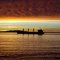 Loaded grain ship sailing into the sunset