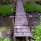 FLT M17 12.0 mi - Bridge east of Curtis Rd, 18' long, 1x6x18 in deck, 2x10 stringers, 4x4 post sills, 3' to drainage