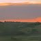 Contrasting Orange Sunset Colours Over The Green Of The Battle River Valley Near The Wainwright Trestle Bridge Southeast of Edmonton Aug '11