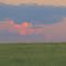 Contrasting Red And Crimson Sunset Skies Over Tranquil Green Prairies Near The Wainwright Trestle Bridge Southeast of Edmonton Aug '11