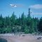 de Havilland Otter taking off after dropping off hikers on pristine beach of Lake Athabasca