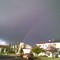 A Rainbow Set Against Dark Skies in Edmonton
