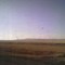 Power of the Future - A Wind Turbine in the Prairie With the Alberta Foothills as a Backdrop