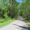 Former railway bed built by the Canadian Northern Railway (CNoR) in 1912 and closed in 1931.  Now a private driveway.  Looking south east.  Follow this line and you can see it curve to the left and run along the bay again.  The line ran from Toronto to Napanee along the lake shore, then north to Ottawa. The Napanee Ottawa stretch to Smith Falls is now the Cataraqui Trail.