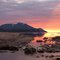 Colored Rocks. Sun setting behind the mountains of Baffin Island.