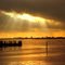 Sun shinning through a cloud hole on the icy water of Lake Zwischenahn, near Oldenburg, Germany