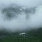 Snowfields and waterfalls make a brief appearance through the clouds above Lynn Canal. July 27, 2012