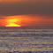 Sun dropping in sea.