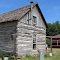 1858 Volkman Cabin with 1901 Parker Carousel in Background, Hertiage Ctr, Abilene, KS