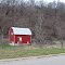 Red barn next to hill