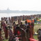 Ritual bath in the Gange at Navadwip with Prabhupada Samadhi on the other side at Mayapur