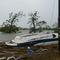 A damaged boat sitting next to the Red Bluff bridge on Taylor Lake