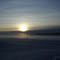 Winter sunset on foggy field