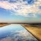 Water On Its Silent Journey South ReflectsThin Dry Desert Clouds
