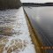 Water spilling over the dam.