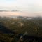 Mt Bosavi with Pioneer Camp for new Komo International Airport airstrip just below cloud line