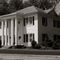 The Robertson House at 308 South Green Street is an excellent example of a well-kept early Georgian Colonial type house, with it's two-story frame structure and white columns with balcony.  The site was the home of Susan P. Hartsfield, wife of W.H. Hartsfield, pioneer citizen of Thomaston.  It was later purchased in 1860 by Edmond B. Atwater, and in the 1880's was bought by Dr. Alfred H. Black, who added the second story and built the stables and cook's cottage, which are still standing in the r