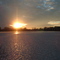 Dec 2004 - Worthington, Minnesota. Winter sunset shining on the ice of Lake Okabena.