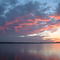 Dec 2004 - Worthington, Minnesota. Winter sunset clouds reflecting on the frozen Lake Okabena.