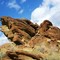 Rock formation against clouds