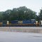 An EMD SD40-3 (CSX 4003) and a General Electric ES44DC (CSX 5448) diesel locomotives heading up freight train through Acworth, Georgia.