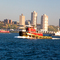 Tug on the Hudson, West New York, NJ behind