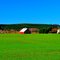 Red house on a green farm