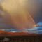 Rainbow at sunset in virga, near Shoshone, California
