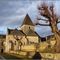 LA CASSAGNE [24] - Eglise Saint-Barthélemy et presbytère en arrière-plan  -XIIème et XVIème siècle- (février 2009)