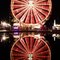 Riesenrad an der Luzerner Määs, spiegelt sich im Wasserbecken vor dem KKL.