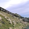 An aqueduct, a water supply or navigable channel (conduit) that is constructed to convey water from one location to another. This one is broke and has been abandoned for many a year.  Seen on "Old U.S. 10".