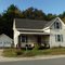 L shaped house with a porch.