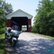 Motorcycle tour crosses covered bridge near Scipio