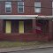 Making abandoned homes look better in wilkinsburg by painting the plywood door and window coverings