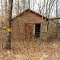 Another old wooden structure with a metal roof.