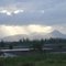 Rays of sunshine illuminate the mountain on a stormy day