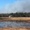 RO Ranch visitor center under construction with smoke from a prescribed burn