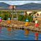 Lago Titicaca - The flowtings Islands of Uros - At the background Puno - 3800m.-  PERU - [By Stathis Chionidis]