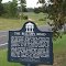 historic plaque for historic Bellamy Road, actual road in distance