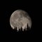 moon rising behind mount olympus