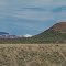 Temporary grassland. Junipers recently burned, cut, and piled. Tushar Mtns. in distance