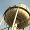 Worker looks down from the water tower during dismantling