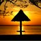 Sunset at Pedhe beach with the hut