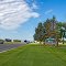 Alongside the Powell Highway (U.S. Hwy. 14A) and in front of the Homesteader Park Rest Area (1000 U.S. Hwy 14A), viewing west-south-westerly toward the east city limits of Powell, Wyoming