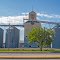 Viewing south-south-easterly at grain elevator and silos from across W. Coulter Ave. (U.S. Hwy. 14A), at its intersection with S. Absaroka St. (Wyo. State Hwy. 295). Powell, Wyoming