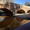 Bridge over Hughes Creek, built in 1850 (2012). Legend has it that a 10-year-old Ned Kelly saved a drowning boy, Richard Shelton, in this creek and was awarded a green sash for doing so. He was wearing this sash when captured at Glenrowan