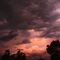 sunset light channelling down through thunder-heads